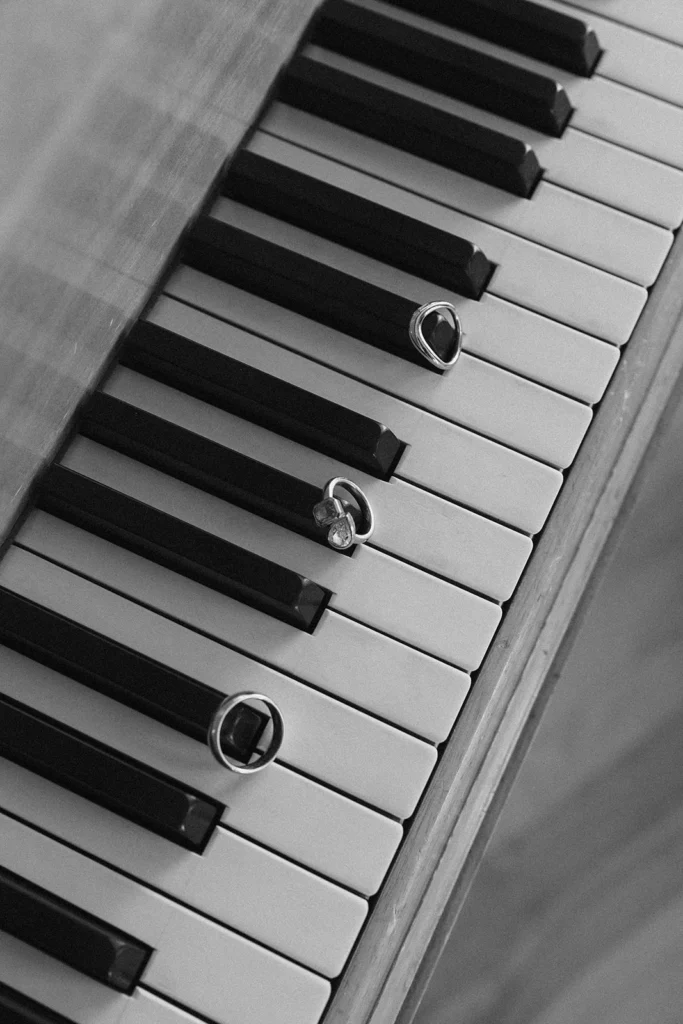 A piano with wedding rings over it