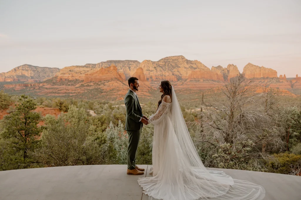 Wedding couple holding hands together overlooking the red rock landscape of Sedona, Eagle Dancer Resort 
